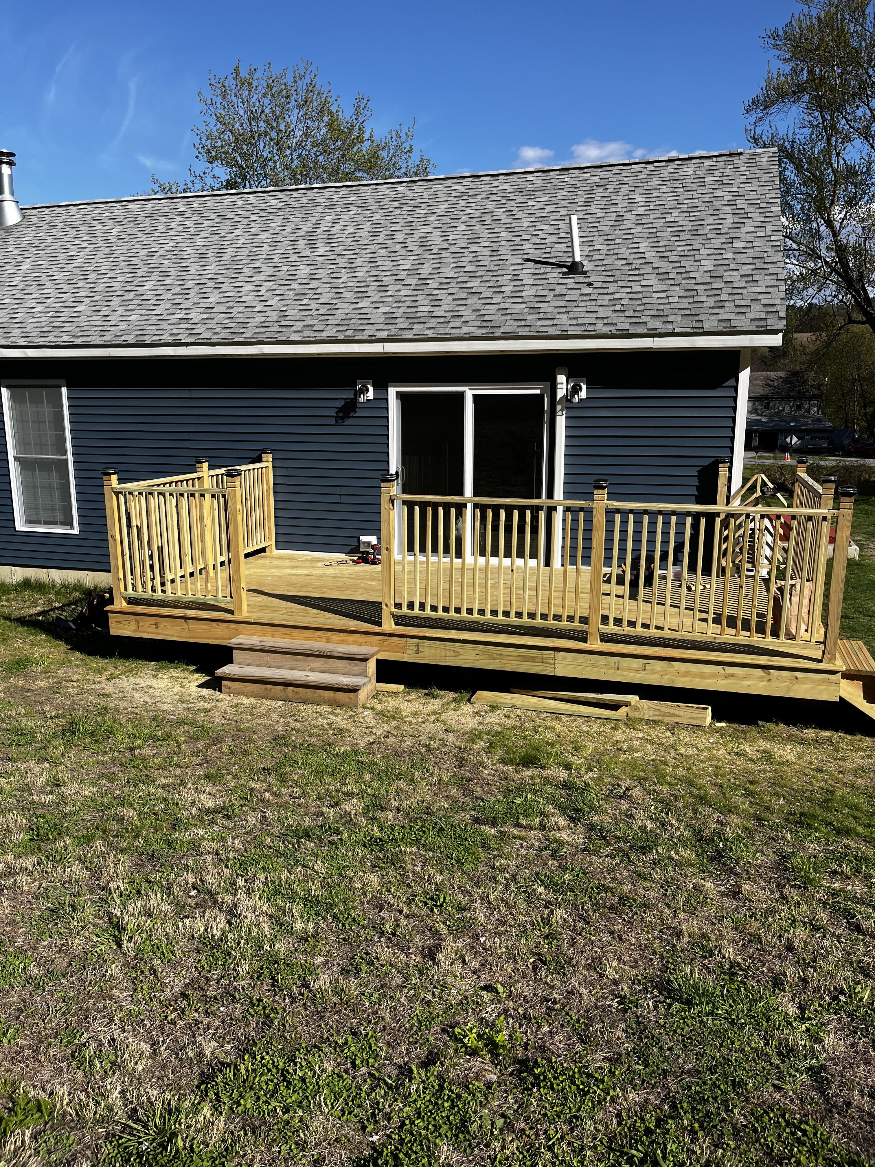 Wide view of the completed deck and rear of the home.